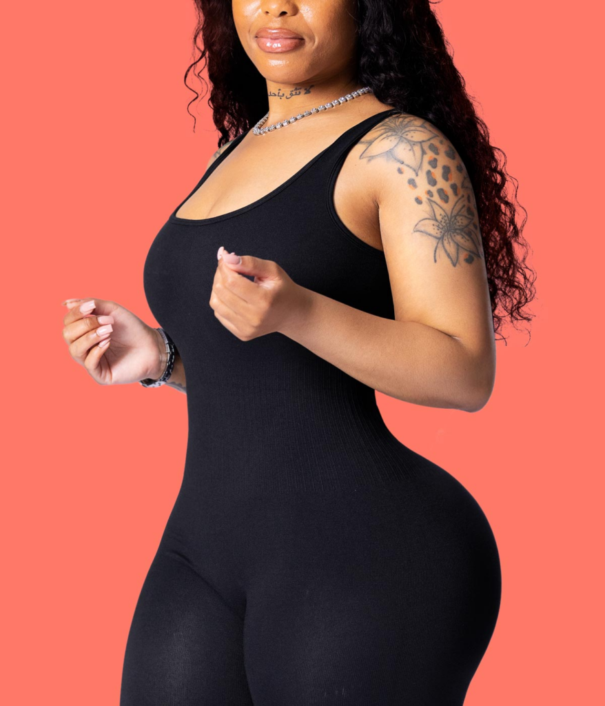 Tatted BBL baddie in form fitting jumpsuit
